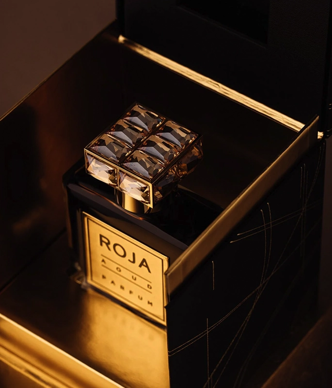 aoud roja parfums cude perfume bottle, gold label, inside gold box with black shadows
