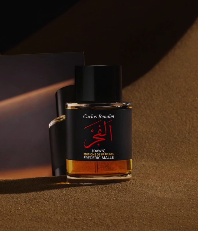 Dawn Frederic Malle perfume bottle with black label in front of sand colour background 